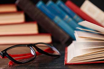 Books and a pair of reading glasses