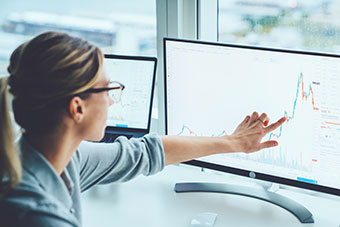 A person pointing at a computer screen