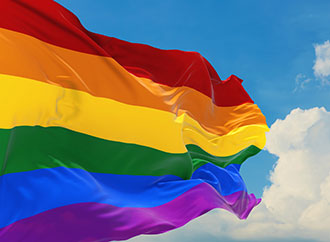 Flag with LGBTQ colours, the sky as a background