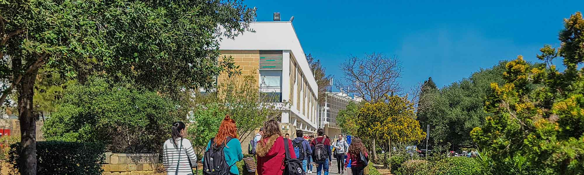 Msida campus with students walking along Vjal Tessie Camilleri