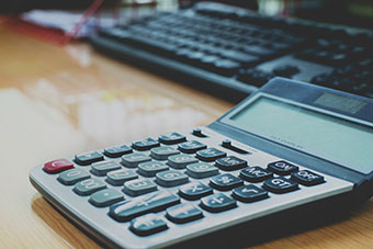 Calculator and keyboard on desk