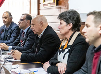 Group photo in the Council Room and a close shot of some of the participants during the forum