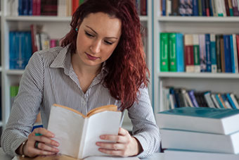 Student reading book in Library