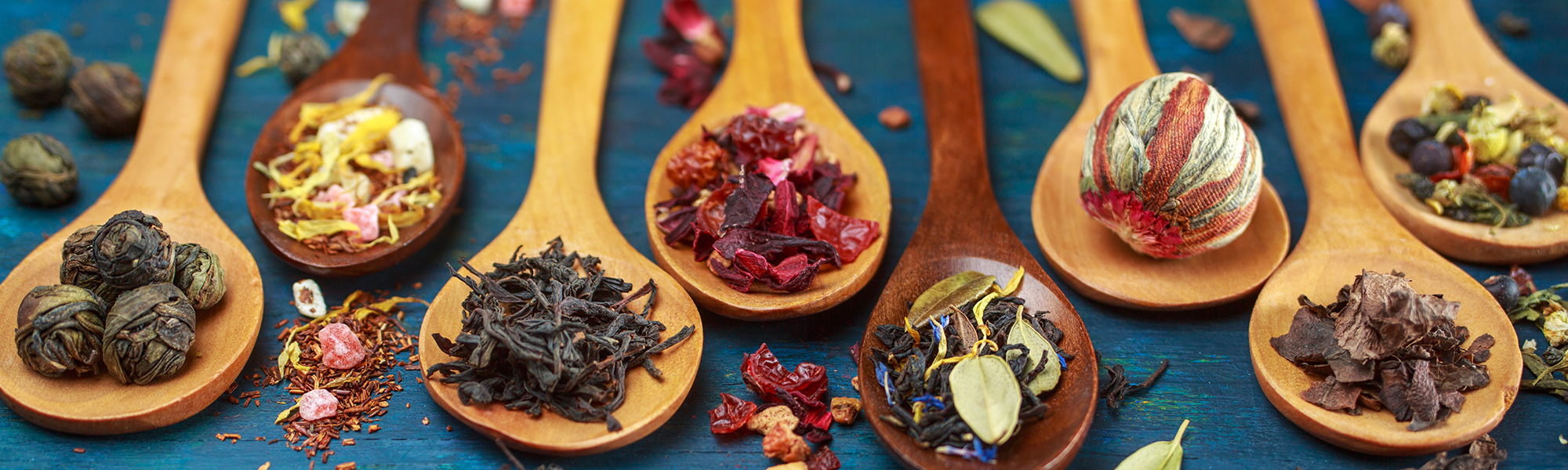 Dry tea with in wooden spoons