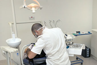 A male dentist working on a patient in the dental clinic