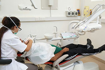 A female dentist working on a patient in the dental clinic