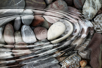 A photo of some pebbles in clear water