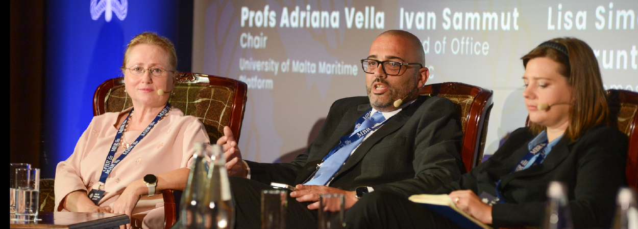 A panel of three speakers during a conference