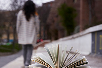 A woman, with her back to the camera, walking along