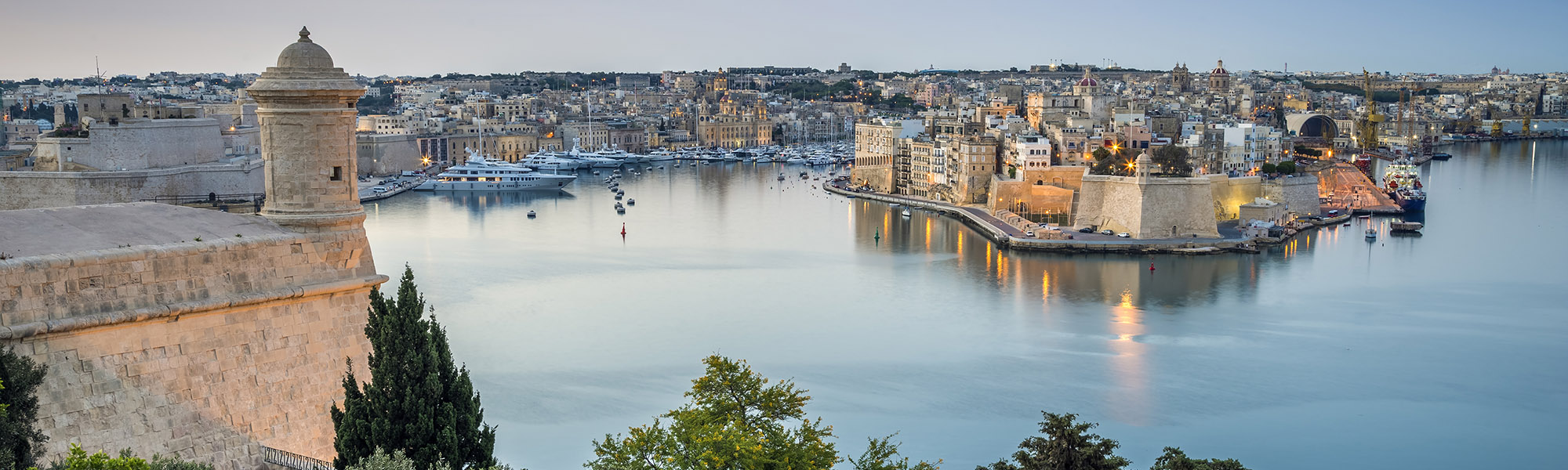 Valletta, Malta - Early morning skyline view of the Grand Harbour of Malta with watch tower and Senglea at the background